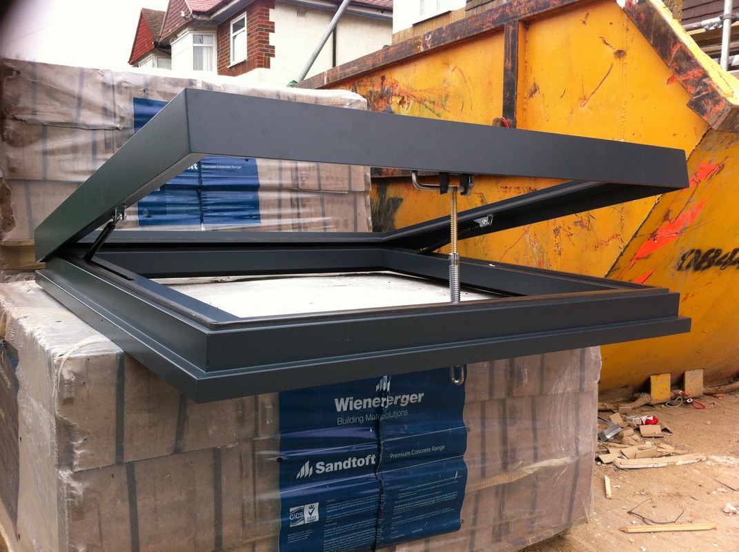 Opening flat roof skylight in anthracite grey installed in Stamford Hill